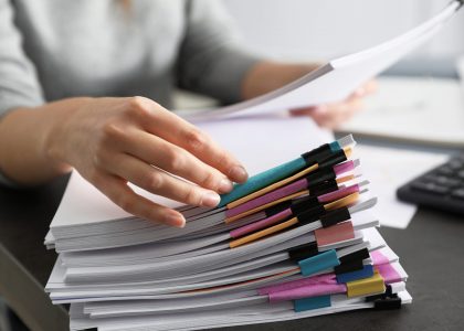 Office employee working with documents at table, closeup